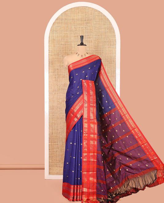 Dark Blue Softy Silk Saree, Delicately Woven With Zari Buttas All Over Its Body, Complemented by Contrast Traditional Zari Varisai Pettu Border, Grand Pallu, and Paired with a Contrast Blouse