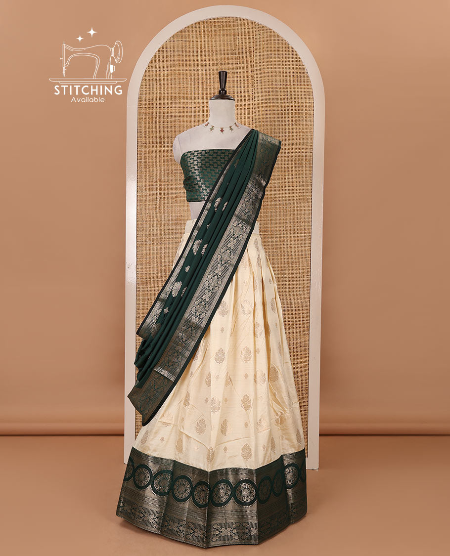Cream-bottle green semi-banaras half-saree, zari buttas & contrast traditional zari border skirt, jacquard blouse & intricately zari woven dhavani