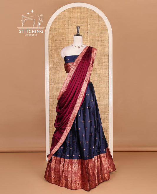 Navy blue taffeta silk half saree, zari buttas with contrast magenta traditional zari border skirt, matching zari design blouse, and contrast plain zari border syska georgette dhavani