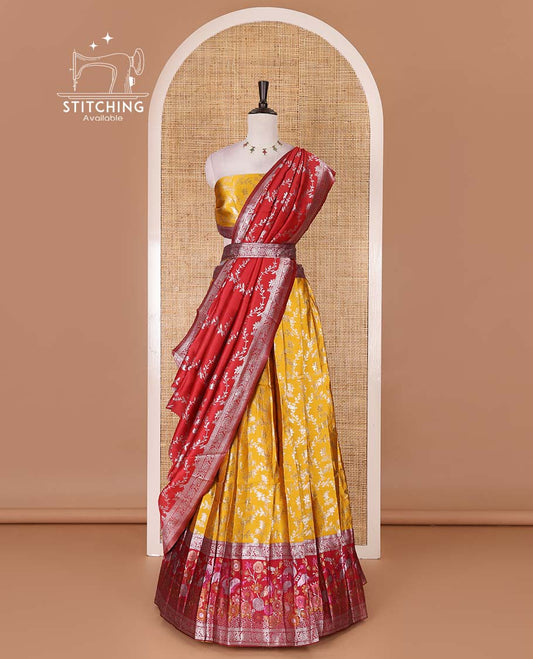 Haldi yellow taffeta silk half saree, floral jaal jacquard skirt, contrast magenta zari meenakari style bird border, matching blouse, and floral jaal dhavani