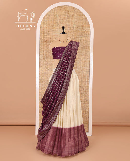 Cream-wine Vichitra half-saree, plain and contrast bordered skirt, contrast leaf buttas blouse, dhavani of buttas and floral creeper designs