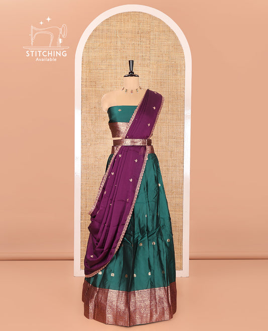 Green and Purple Semi-Banarasi Half-Saree, Adorned with Zari Buttas on Its Skirt, Complemented by a Contrast Traditional Zari Designs Woven Border, Paired with a Matching Blouse, and a Satin Georgette Embroidered Scallop Dhavani
