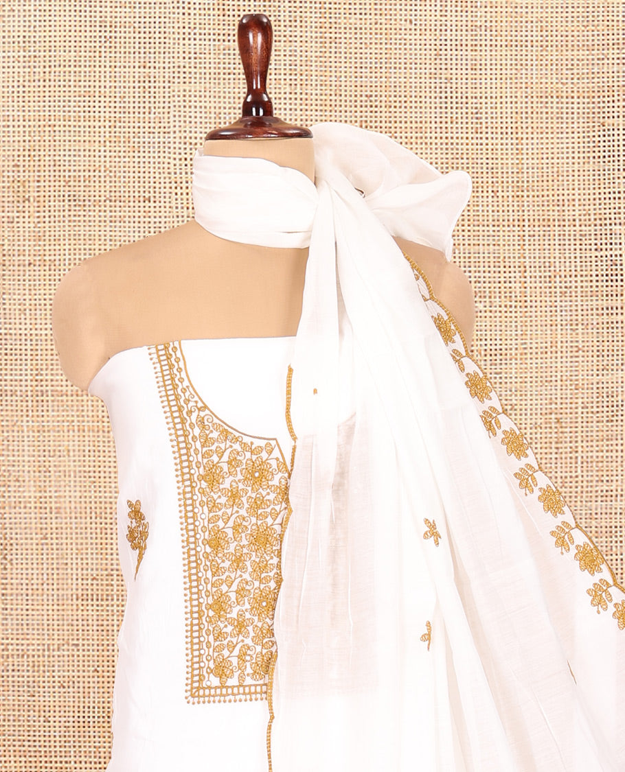 White-Mustard Mul Chanderi Material Churidar Features a Floral-Themed Thread-Embroidered Top, a Plain Santoon Bottom, and Thread Embroidered Dupatta