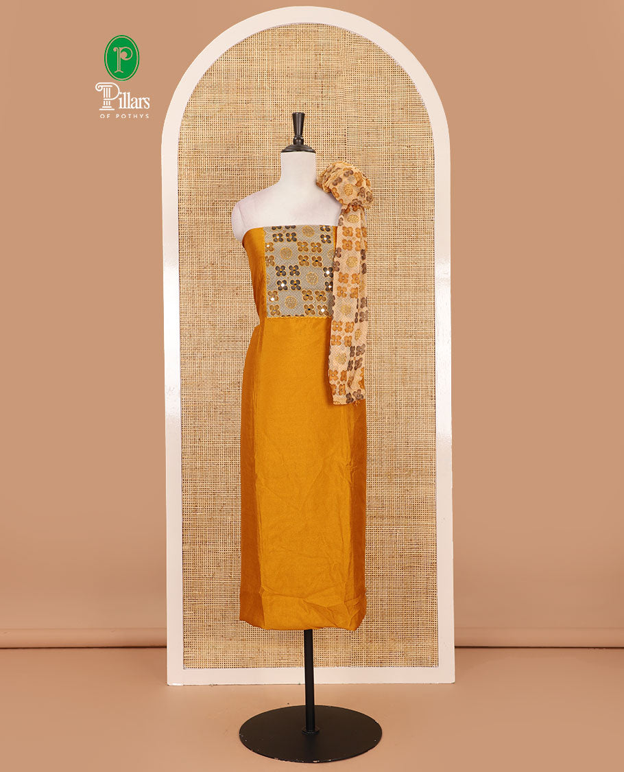 Mustard Vichitra silk material chudidar set, brasso print & mirror embroidered neck work top, santoon bottom & four-petal floral motifs printed dupatta