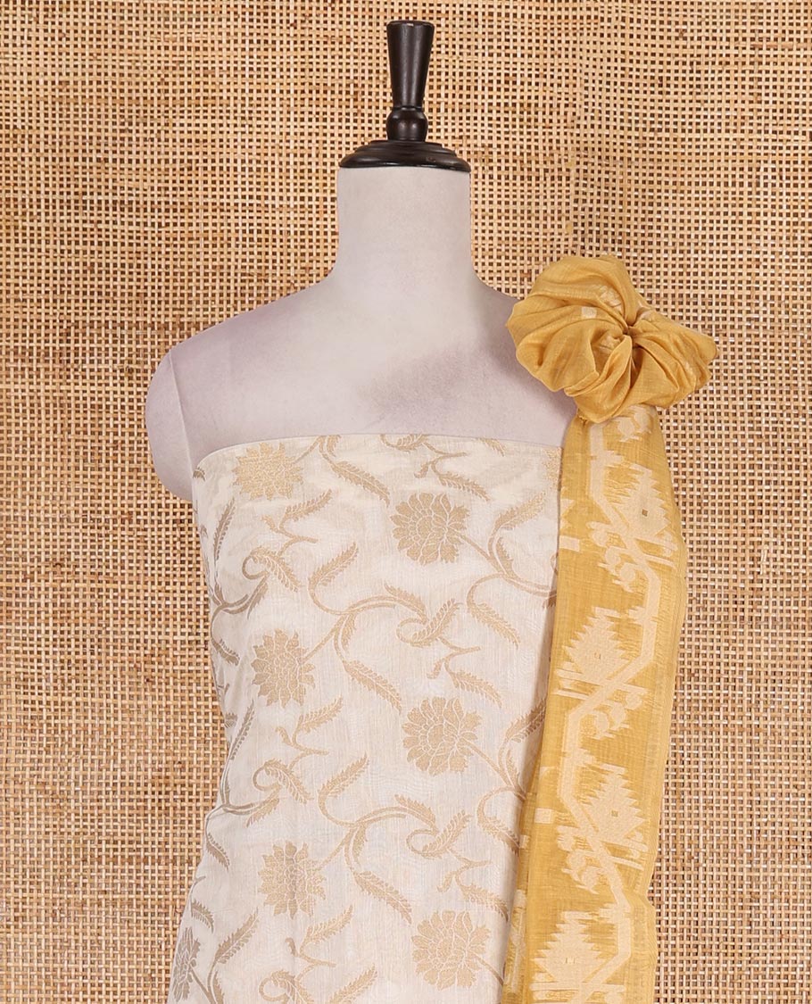 Cream with yellow semi-chanderi material churidar set, floral jaal jacquard top, contrast taffeta silk bottom, and jamdani style dupatta