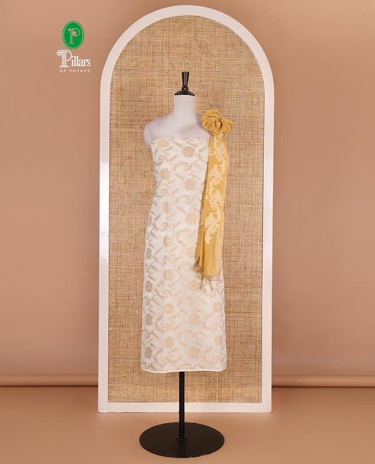 Cream with yellow semi-chanderi material churidar set, floral jaal jacquard top, contrast taffeta silk bottom, and jamdani style dupatta