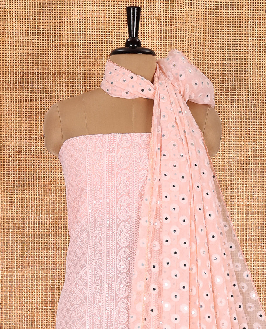 Light peach material chudidar set, paisleys and jaal schiffli sequins embroidered mul georgette top, a matching bottom, and a mirror work dupatta