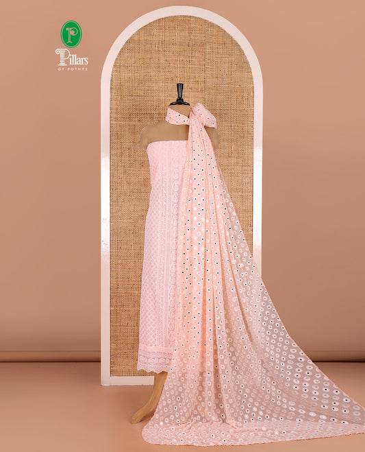 Light peach material chudidar set, paisleys and jaal schiffli sequins embroidered mul georgette top, a matching bottom, and a mirror work dupatta
