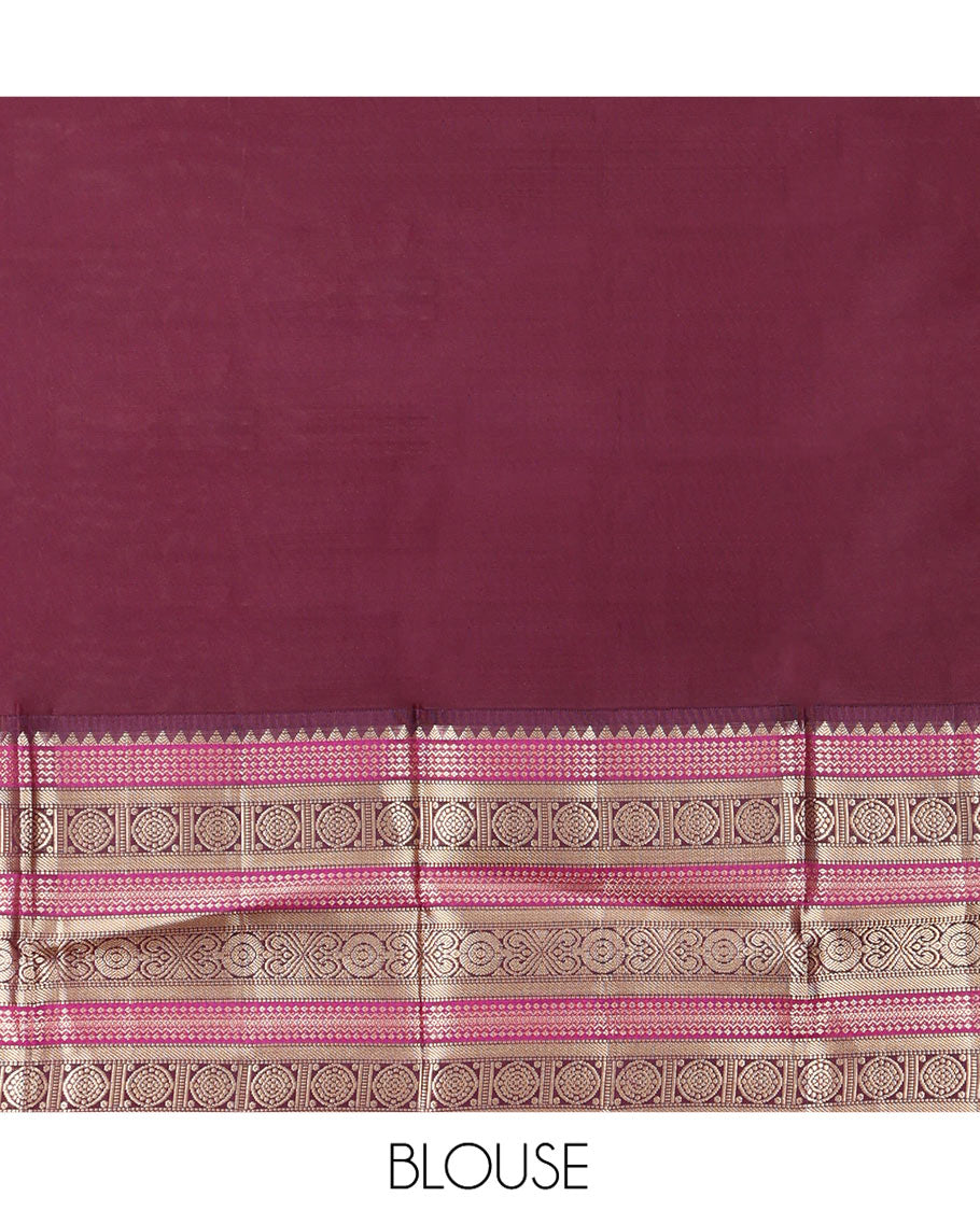 Yellow Vasundhara Silk Saree Subtly Sparkled with Buttas Enclosed Checks All Over Its Body, Complemented by Contrast  Border of Rekku, Chakram, and Jada Nagam Designs, a Grandly Woven Pallu of Intricate Mughal Designs, and Paired with a Contrast Blouse