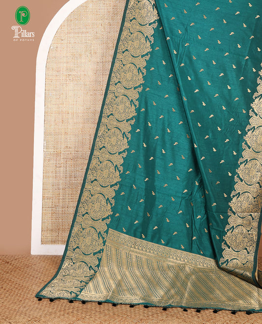Bottle green zari peacock butta dola raw silk saree with kancheepuram zari border with geometrical zari pallu along with plain blouse