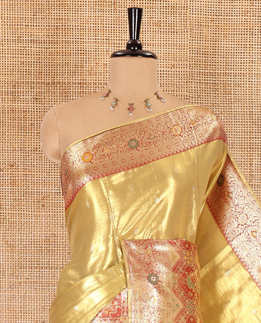 Gold zari buttas tissue silk saree, contrast border of patola design and traditional motifs, jaal pallu, and a matching blouse