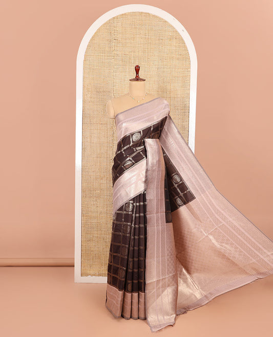 Coffee Brown and Pink Litchi Saree Gracefully Embellished with Chakra Butta Enclosed Zari Checks, Complemented by a Contrast Border Steeped with Chakram Motifs, Pallu Featuring Intricate Designs, and Comes with a Contrast Blouse