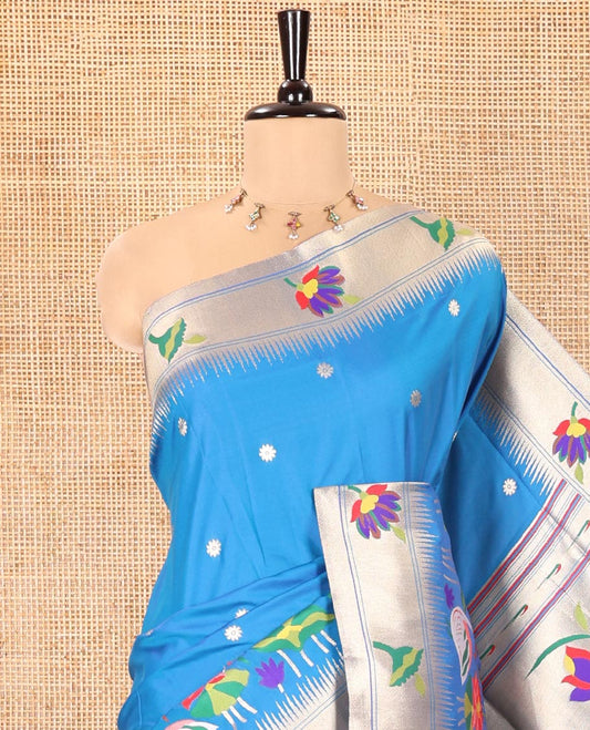 Blue Paithani Art Silk Saree, Accentuated with Flower Buttas All Over Its Body, Highlighted by Zari Temple Border Pictures Colorful Flora-Fauna Designs, Pallu Depicts Colorful Floral and Bird Designs, and Paired with a Matching Blouse