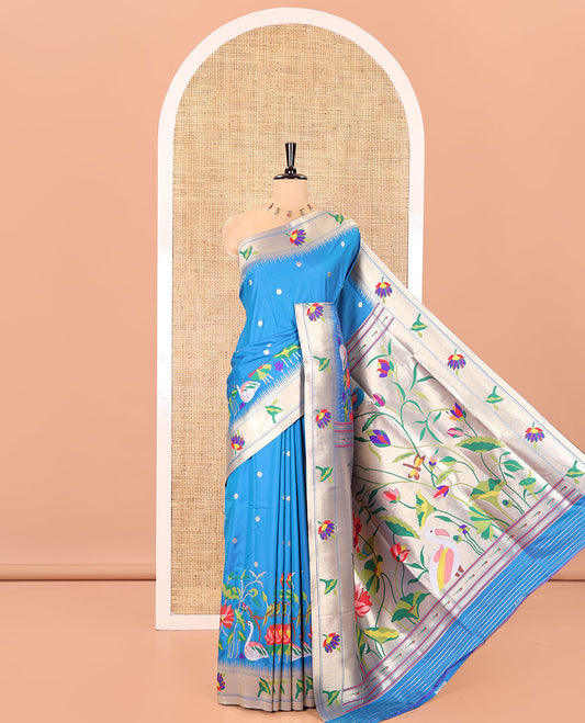 Blue Paithani Art Silk Saree, Accentuated with Flower Buttas All Over Its Body, Highlighted by Zari Temple Border Pictures Colorful Flora-Fauna Designs, Pallu Depicts Colorful Floral and Bird Designs, and Paired with a Matching Blouse