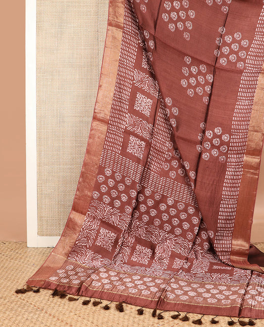 Brown floral and geometric printed banana pith saree, zari border, and printed pallu