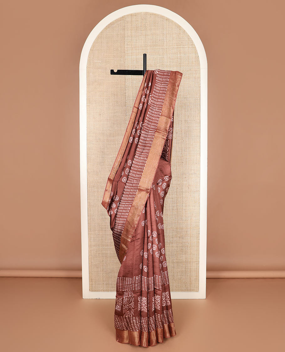 Brown floral and geometric printed banana pith saree, zari border, and printed pallu