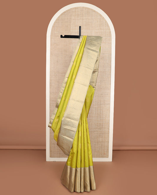 Yellow zari design silk saree, contrast border of rekku, banaras, kamalam, neli, and mayil designs, and intricate pallu