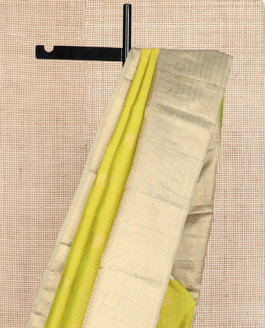 Yellow zari design silk saree, contrast border of rekku, banaras, kamalam, neli, and mayil designs, and intricate pallu