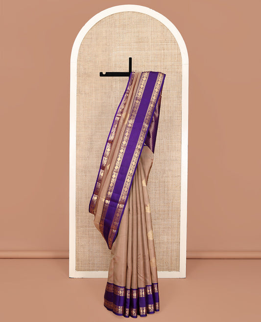 Beige Vasundhara Lite Silk Mix Saree, Accentuated With Zari Buttas All Over Its Body, Complemented by Contrast Rettai Pettu Border of Salngai, Neli, Poun and Mayil Designs, Gleaming Zari Pallu, and Paired with a Contrast Blouse