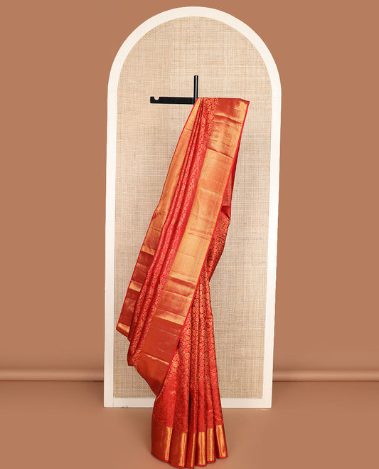 Red jacquard Kanchipuram wedding silk saree, zari border of thilakam, muthu, diamond, and mayil kann designs, and intricate pallu
