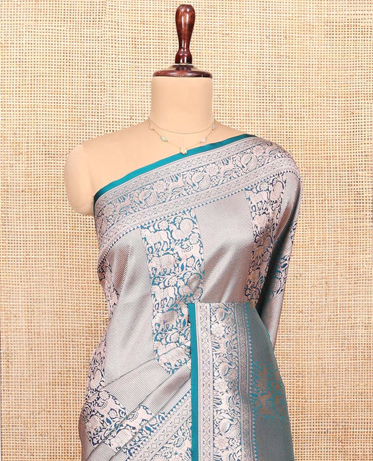 Blue Semi-Banaras Silk Saree, Opulently Embellished with Animal-themed Jacquard Designs on Its Body, Highlighted by a Zari Border of Traditional Designs, Pallu Steeped with Stripes, and Paired with a Matching Blouse