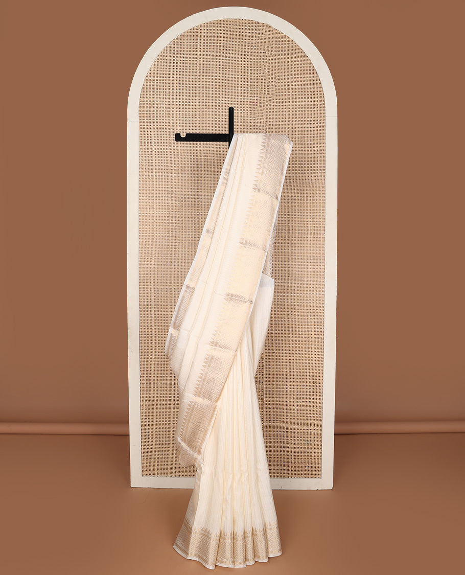 Dazzling white sparsely checked silk saree, traditional zari border, and traditional pallu of paisleys