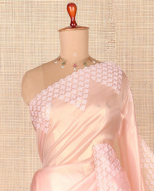 Peach plain designer saree with scallop border featuring floral motifs embroidery arranged in a triangle shape