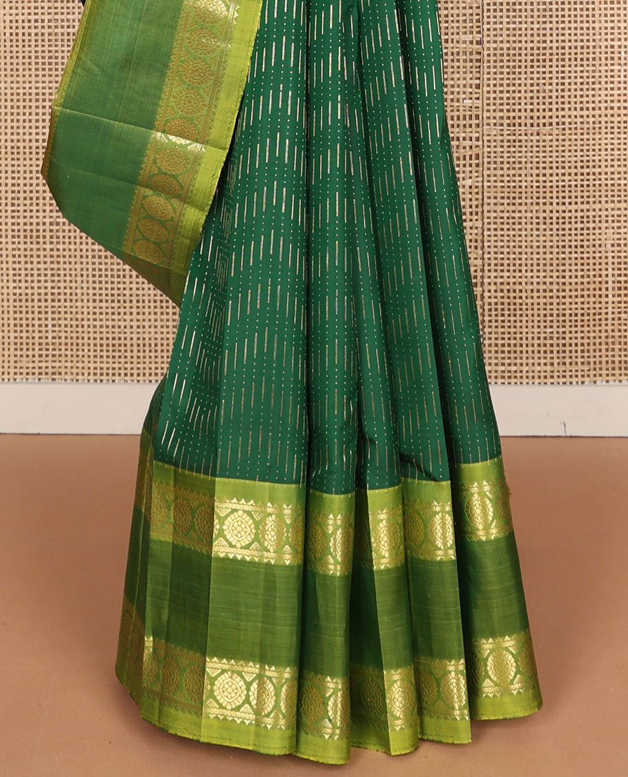 Green zari buttas Kanchipuram silk saree, contrast rettai pettu one-sided border of rekku, banaras, and chakram designs, and floral design pallu