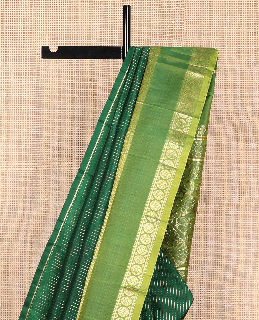 Green zari buttas Kanchipuram silk saree, contrast rettai pettu one-sided border of rekku, banaras, and chakram designs, and floral design pallu