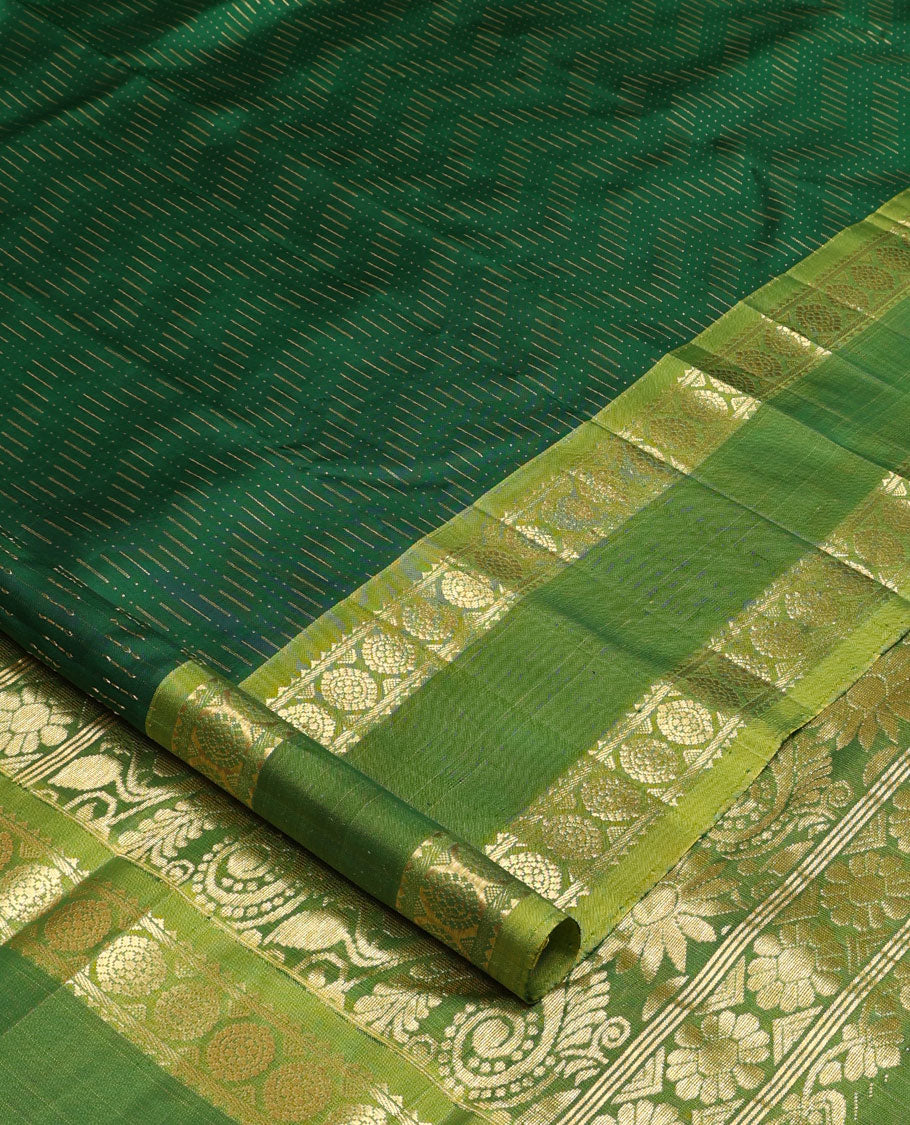 Green zari buttas Kanchipuram silk saree, contrast rettai pettu one-sided border of rekku, banaras, and chakram designs, and floral design pallu