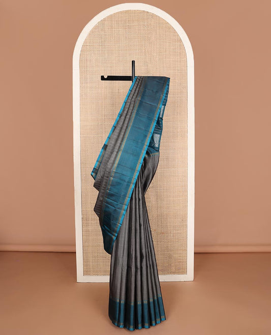 Dark grey striped Kanchipuram silk saree, contrast rettai pettu striped border, and temple zari pallu