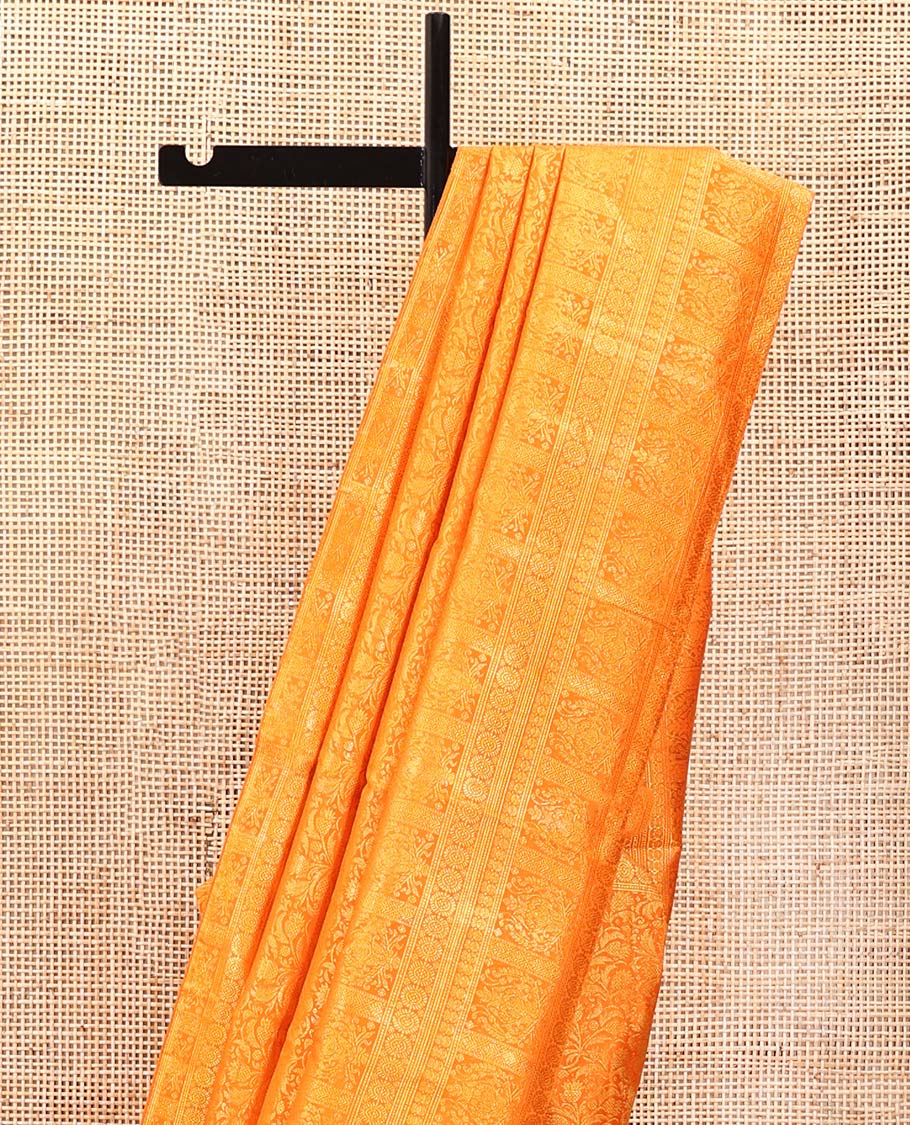 Orange Kanchipuram Designer Silk Saree, Subtly Sparkled With Floral Jacquard Design On Its Body, Highlighted by Meenakari Mughal Intricate Border, Intricate Pallu and Paired with a Matching Blouse