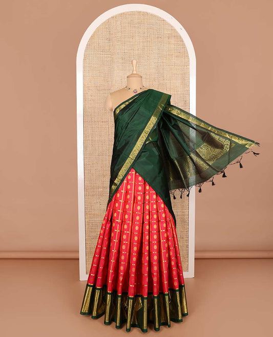 Red pure silk half-saree, chakram enclosed zari checked skirt, contrast border of muthu, poun, arumbu manga and mayil kann, and contrast zari design blouse, and leaf jaal dhavani