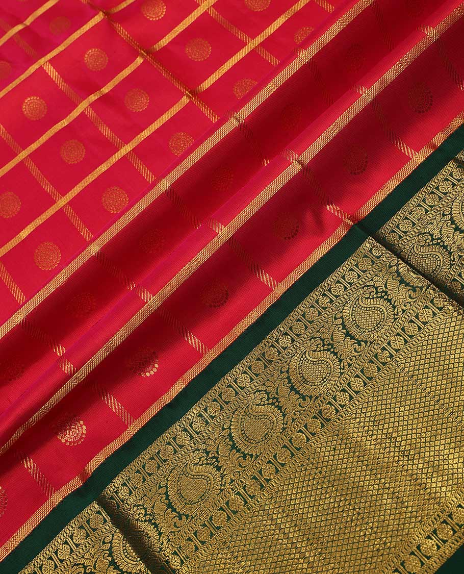Red pure silk half-saree, chakram enclosed zari checked skirt, contrast border of muthu, poun, arumbu manga and mayil kann, and contrast zari design blouse, and leaf jaal dhavani