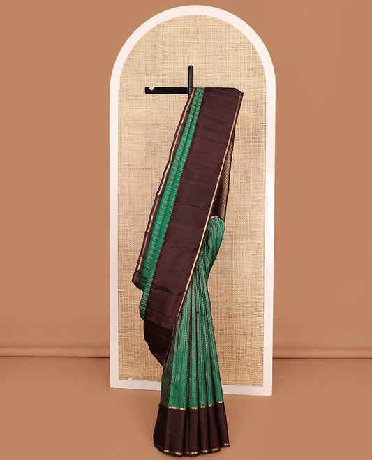 Green Vasundhara Lite-Silk Mix Saree Features Zari Stripes, Complemented with a Contrast Rettai Pettu Neli Striped Border, a Majestically Detailed Pallu with Jaal Designs, and a Contrast Blouse
