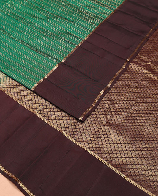 Green Vasundhara Lite-Silk Mix Saree Features Zari Stripes, Complemented with a Contrast Rettai Pettu Neli Striped Border, a Majestically Detailed Pallu with Jaal Designs, and a Contrast Blouse