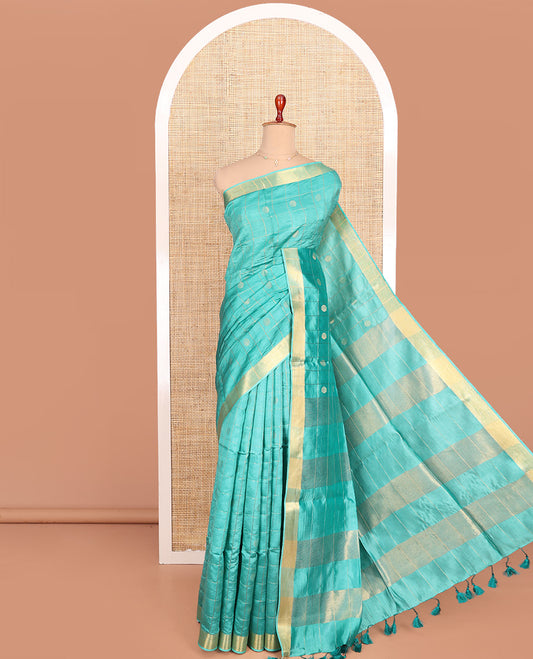 Blue Banana Pith Saree Subtly Sparkled with Polka Dot Buttas Enclosed Checks, Subtle Zari Border, Gleaming Zari Stripes Woven Pallu, and Paired with a Matching Plain Blouse