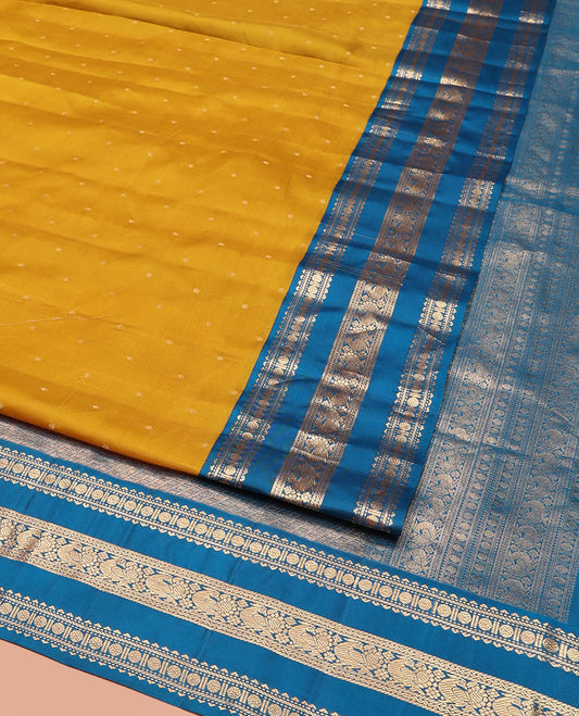 Yellow Vasundhara Silk Saree, Embellished with Zari Buttas All Over Its Body, Complemented by a Contrast Border of Rekku, Banaras, Rudraksham, Neli, and Mayil Designs, Grand Pallu of Geometric Patterns, and Paired with a Contrast Blouse