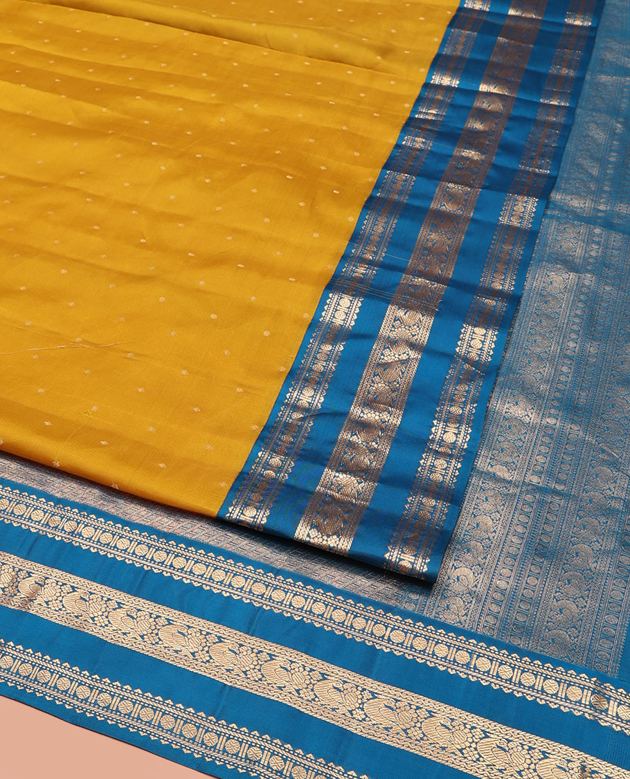 Yellow Vasundhara Silk Saree, Embellished with Zari Buttas All Over Its Body, Complemented by a Contrast Border of Rekku, Banaras, Rudraksham, Neli, and Mayil Designs, Grand Pallu of Geometric Patterns, and Paired with a Contrast Blouse