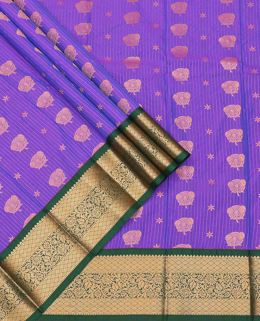 Violet Art Silk Pavadai Material Set, Richly Detailed with Zari Stripes and Floral Buttas on Its Skirt, Complemented by a Contrast Traditional Zari Design Border, and Paired with a Contrast Blouse