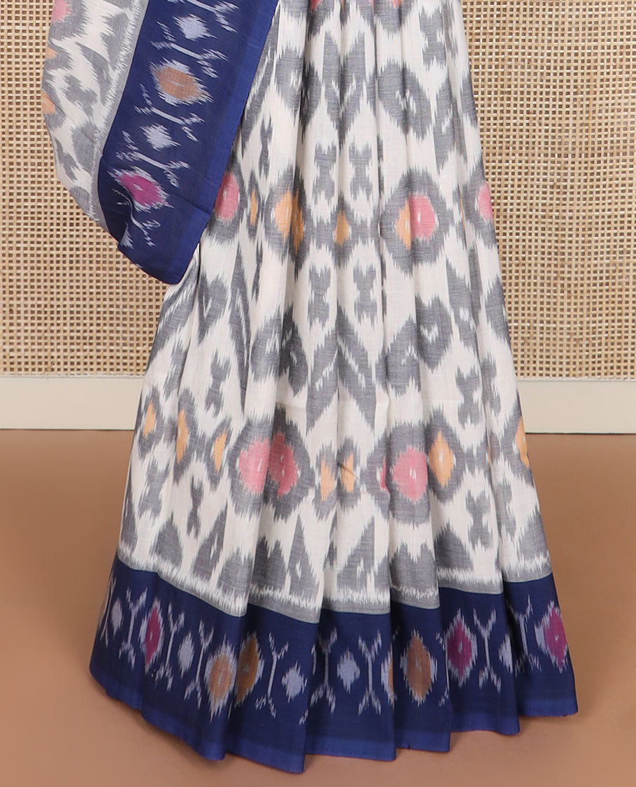 Cream-base unique motifs ikkat cotton saree, contrast ikkat buttas border & pallu of diamond & peacock designs