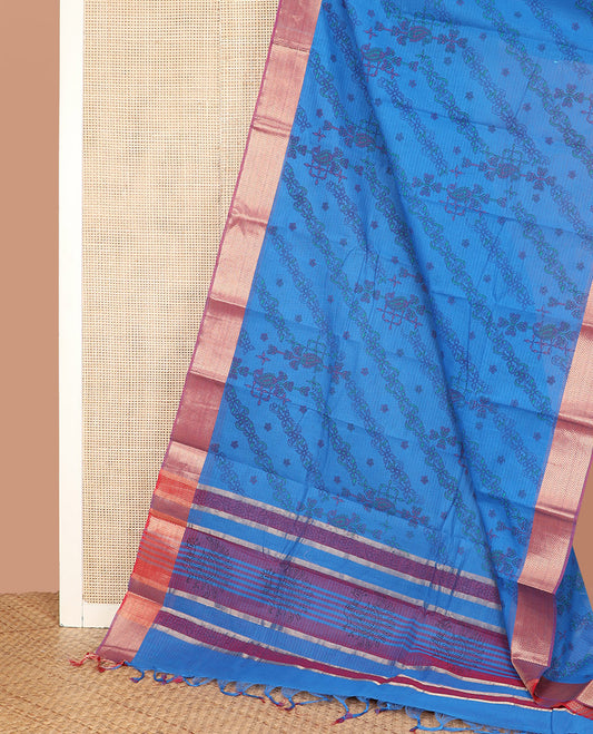 Blue Chirala Cotton Saree, Prettified with Floral-Theme Printed All Over Its Body, Complemented by a Contrast Chevron Striped Border, Subtly Peacock Block Printed Pallu, and Paired with a Contrast Blouse