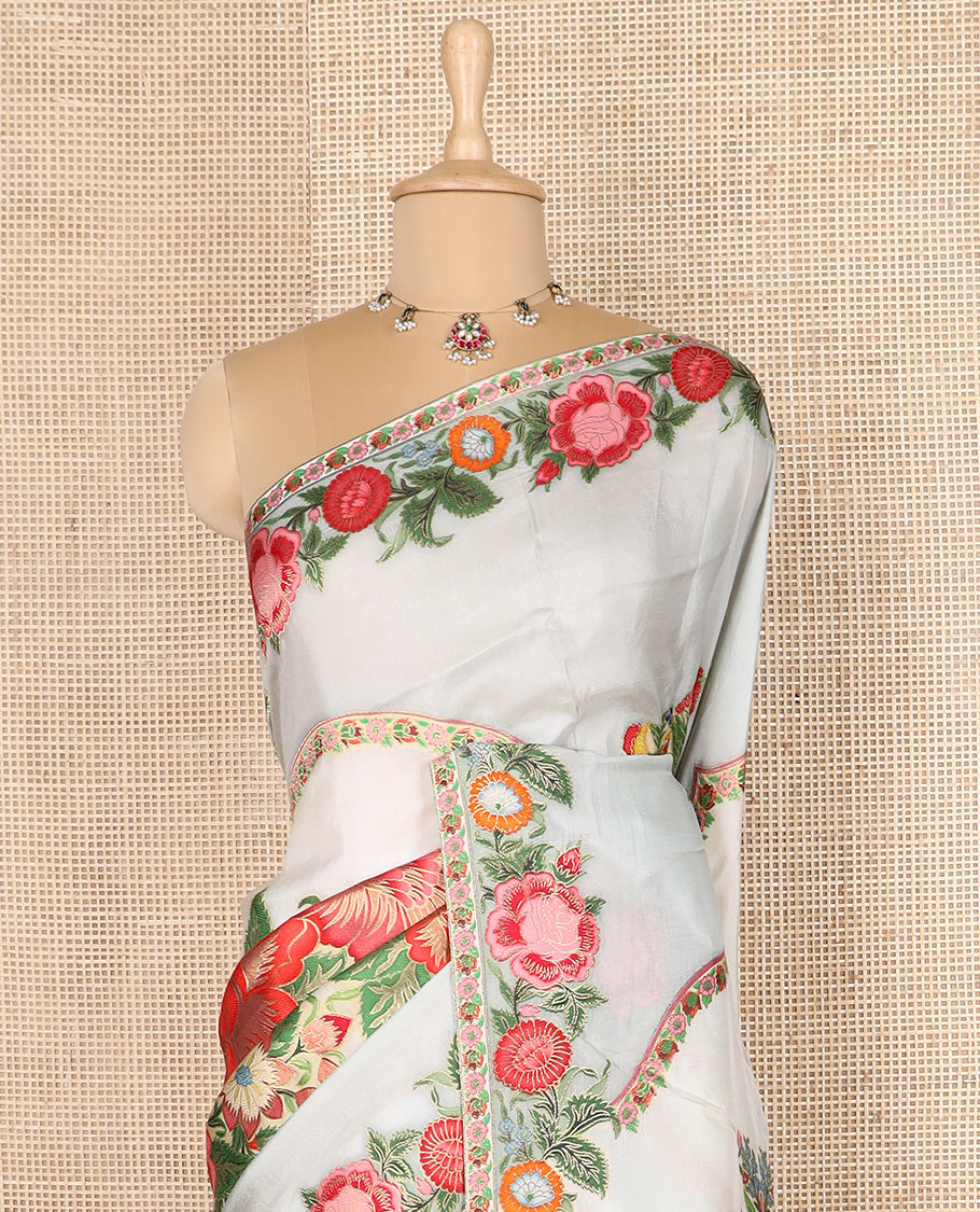 Cream and pastel blue floral buttas dola silk saree, colorful floral design steeped border, and pallu