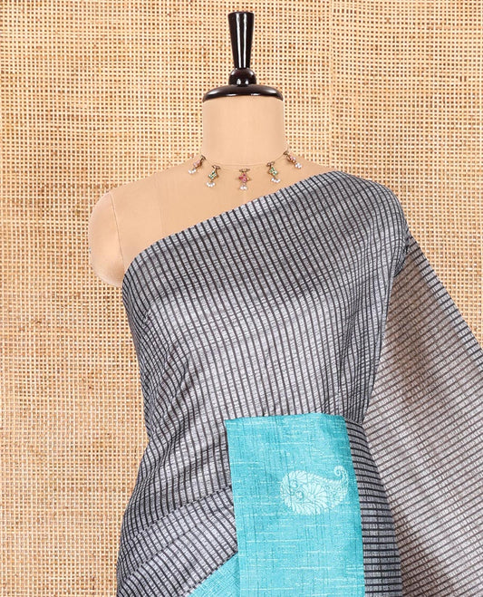 Grey and Blue Semi-Tussar Saree Enthralled with Vertical Stripes Printed Across the Body, Featuring a Contrast Paisley Motif Printed Border, an Intricately Designed Pallu of Jaal Design, and Paired with a Contrast Blouse