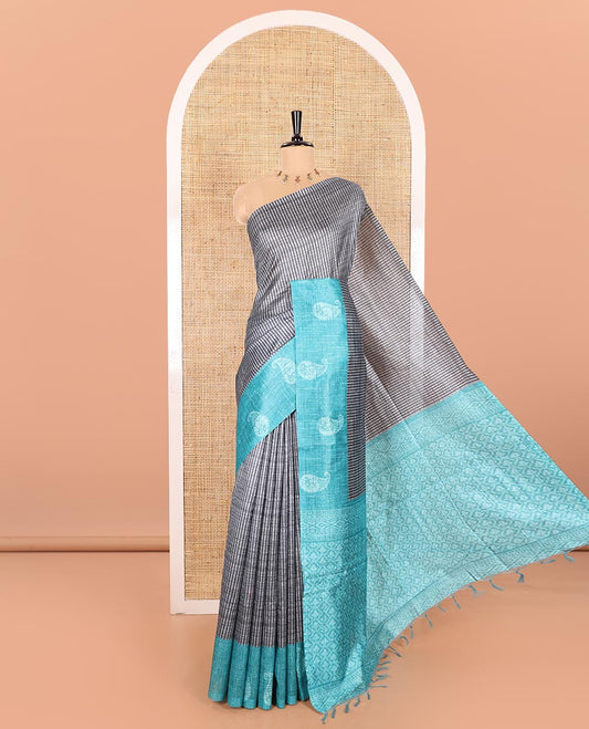 Grey and Blue Semi-Tussar Saree Enthralled with Vertical Stripes Printed Across the Body, Featuring a Contrast Paisley Motif Printed Border, an Intricately Designed Pallu of Jaal Design, and Paired with a Contrast Blouse