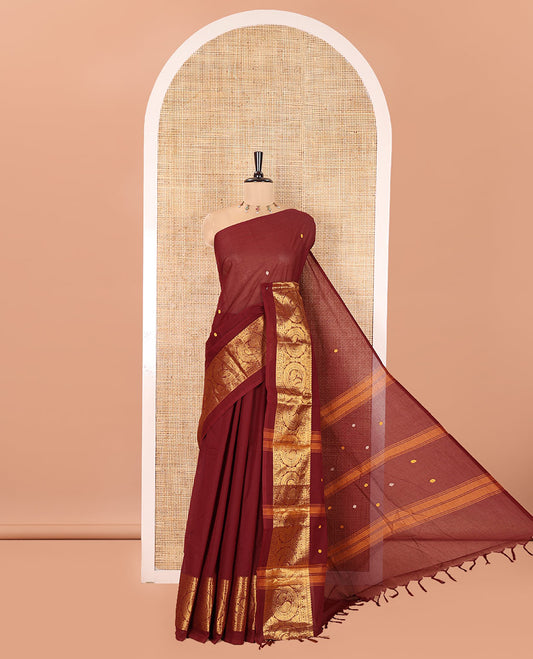 Coffee Brown Chettinad Cotton Saree, Subtly Sparkled with Buttas All Over Its Body, Highlighted Contrast by Zari Traditional Border of Round Chakram Designs, Pallu of Stripes and Buttas, and Paired with a Matching Blouse