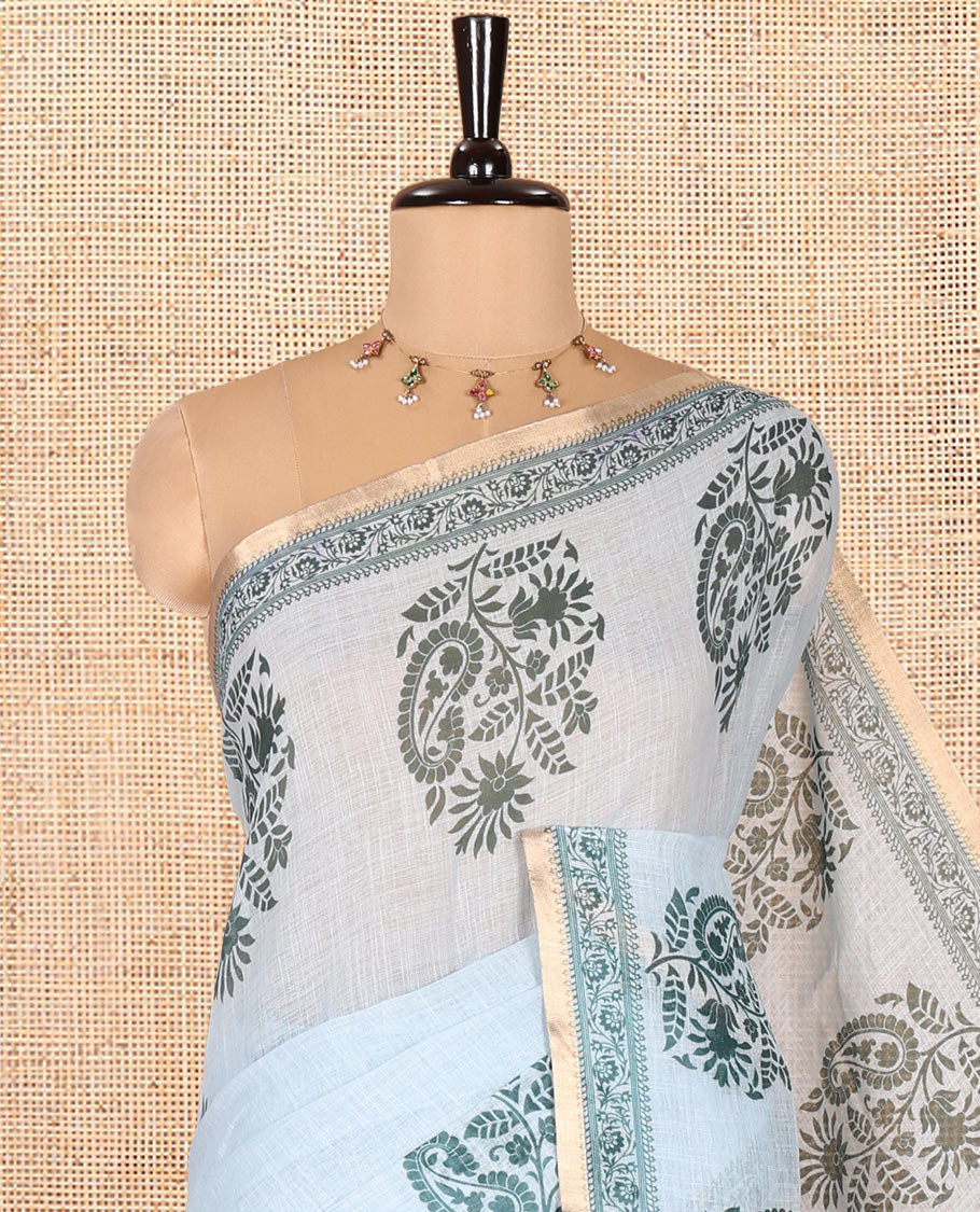 Blue Linen Cotton Saree, Artfully Designed with Floral-Paisley Motifs Print All Over Its Body, Highlighted by Gold Zari Printed Border, Floral-Paisley Printed Pallu and Paired with a Matching Blouse