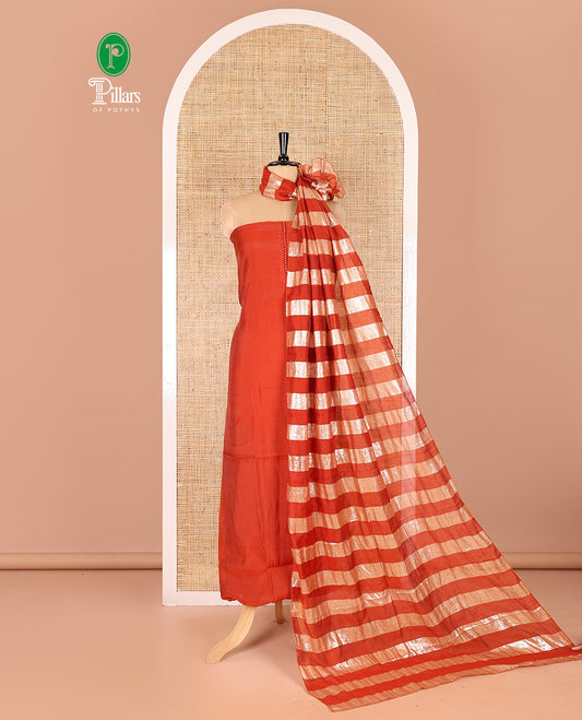 Rust material chudidar set, plain with pom-pom tasseled mul chanderi top, a matching bottom, and organza dupatta of stripes
