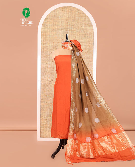 Orange Semi Silk Material Churidar Set, Subtly Made Plain Top, a Plain Santoon Bottom, and Is Paired with a Dual-Colored Bandhani Motifs Semi Silk Dupatta