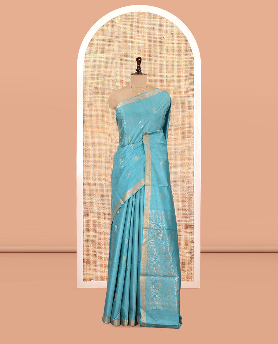 Blue Tussar Saree, Bedecked with Buttas, a Subtle Zari Border, Pallu of Intricate Designs, and a Matching Blouse